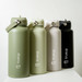 A drink bottle collection featuring four 1L bottles in olive green, cream, light grey, and black, each with a logo. A drink bottle collection featuring four 1L bottles in olive green, cream, light grey, and black, each with a logo.