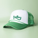 A green and white trucker cap with a mesh back and a logo on the front. A green and white trucker cap with a mesh back and a logo on the front.