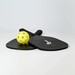 A black pickleball set featuring two paddles and a yellow ball, with a logo on the paddles.