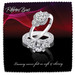 A pair of elegant rings featuring large diamonds and intricate detailing, displayed on a dark, wavy background.