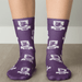 Purple socks featuring a pattern with lions and logos, showcasing a vibrant design and comfortable fit.