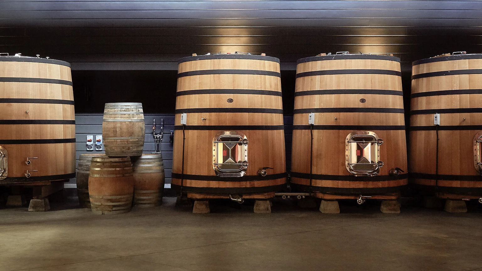 Oak barrels and fermentation vessels representing Martin Ray cellar work