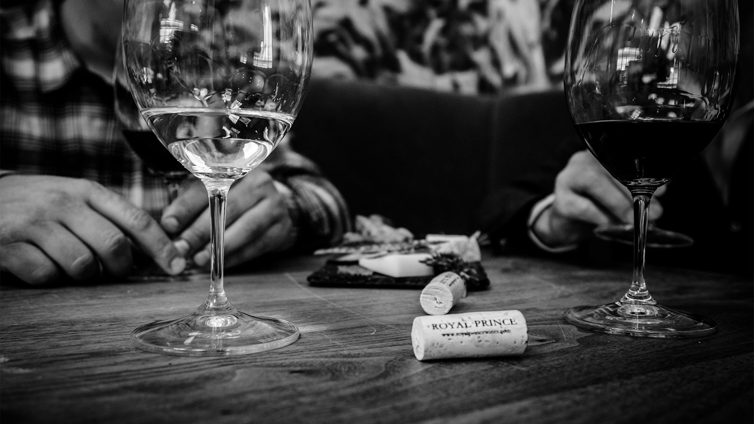 Two wine glasses and a Royal Prince cork on a dining table