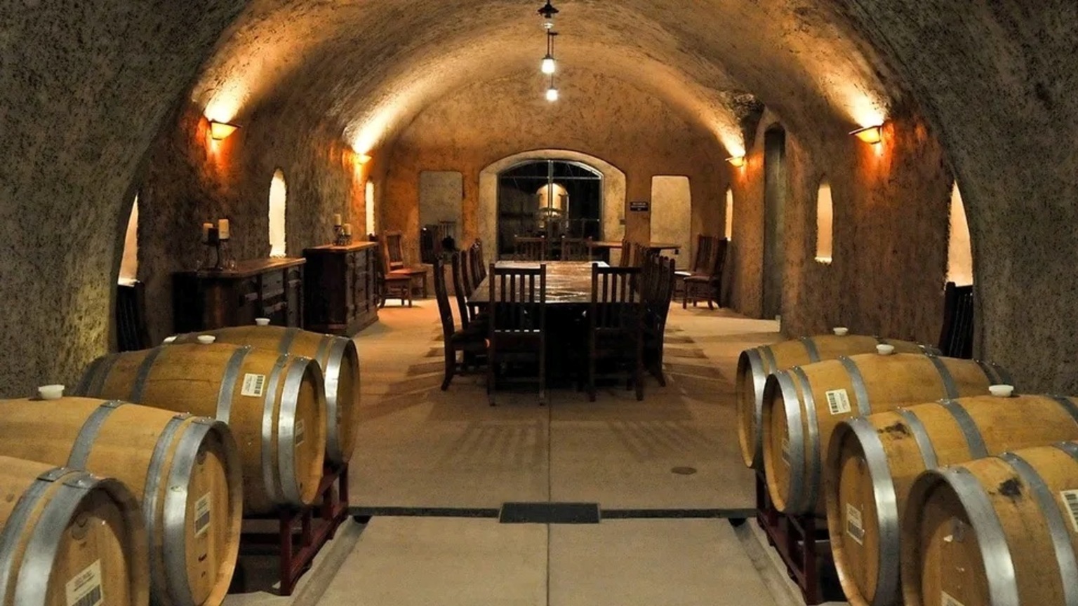 Barrel-lined wine cellar used as production context