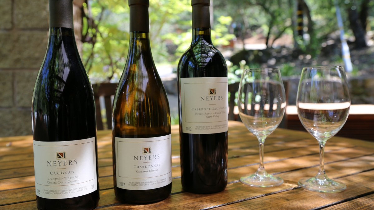 Neyers Carignan, Chardonnay, and Cabernet Sauvignon bottles set for a tasting