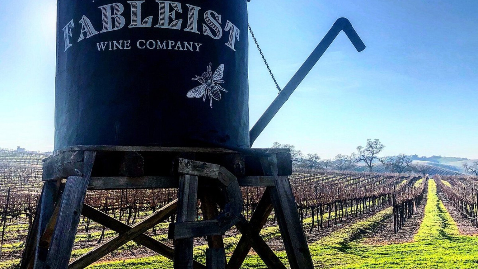 The Fableist water tank overlooking vineyard rows