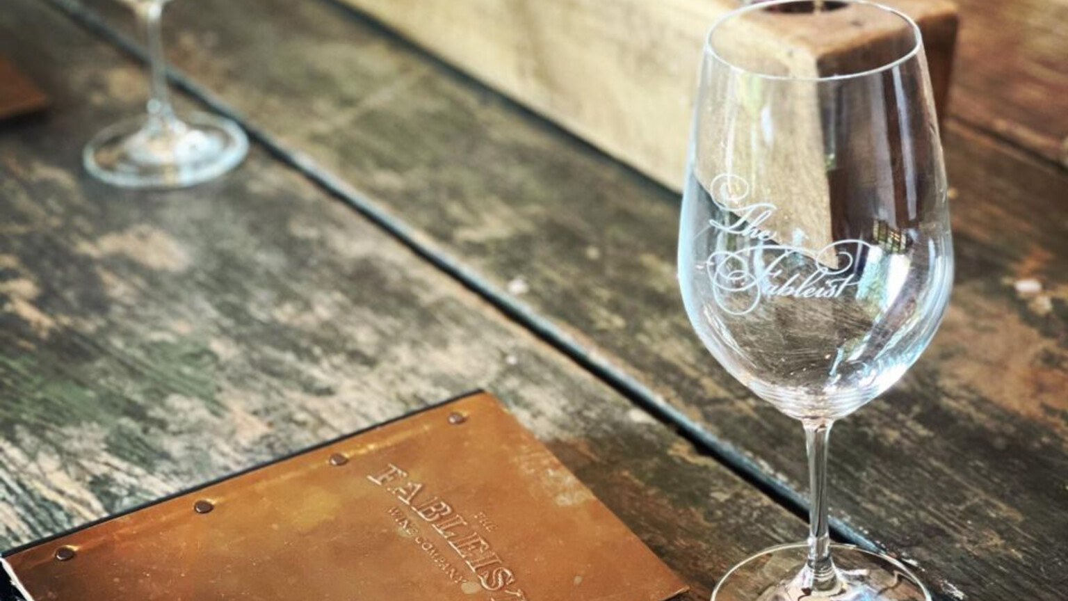 A Fableist tasting glass on a rustic table