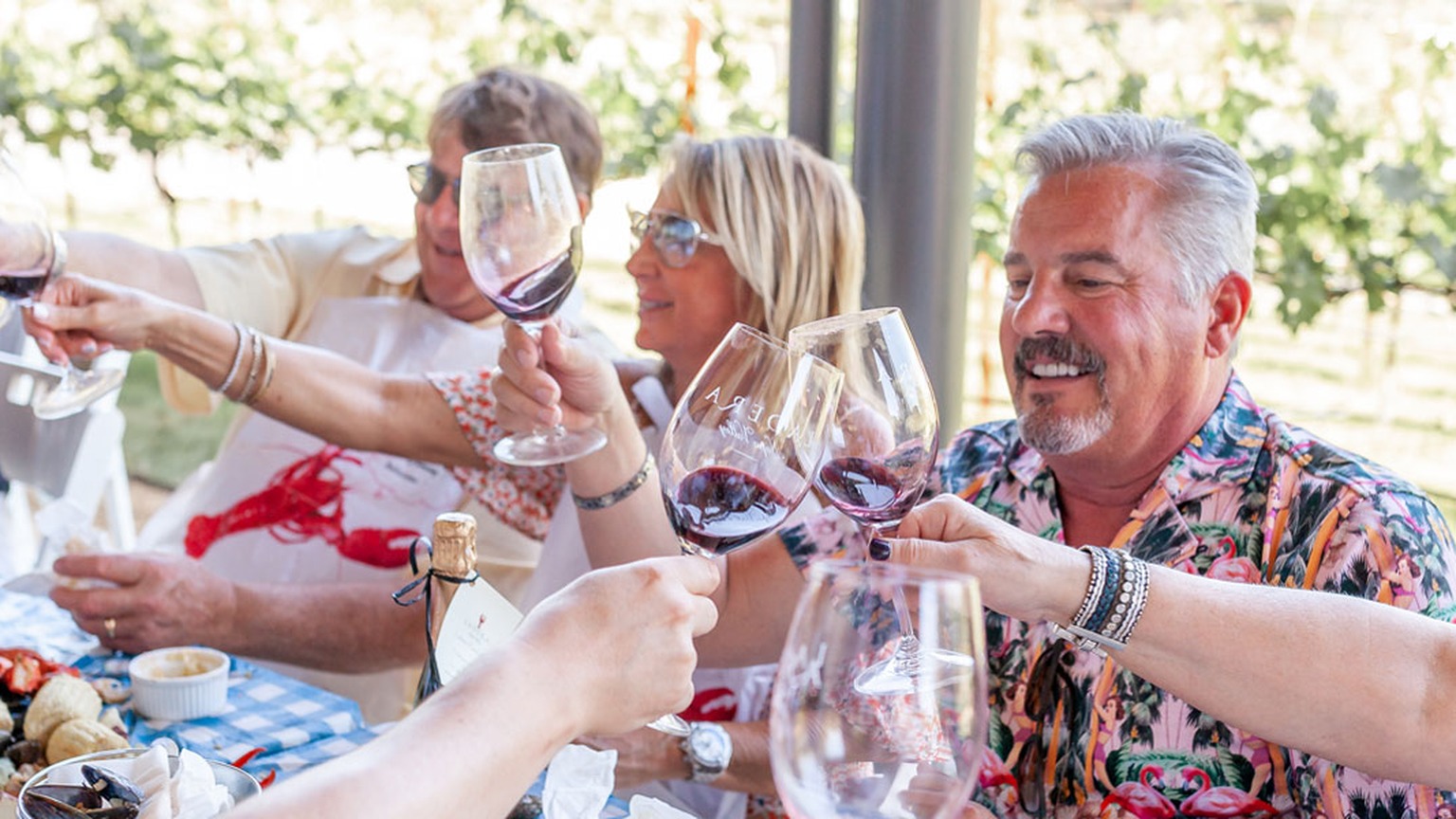 Guests at a Ladera vineyard table. The photograph is not captioned as Pillow Road.
