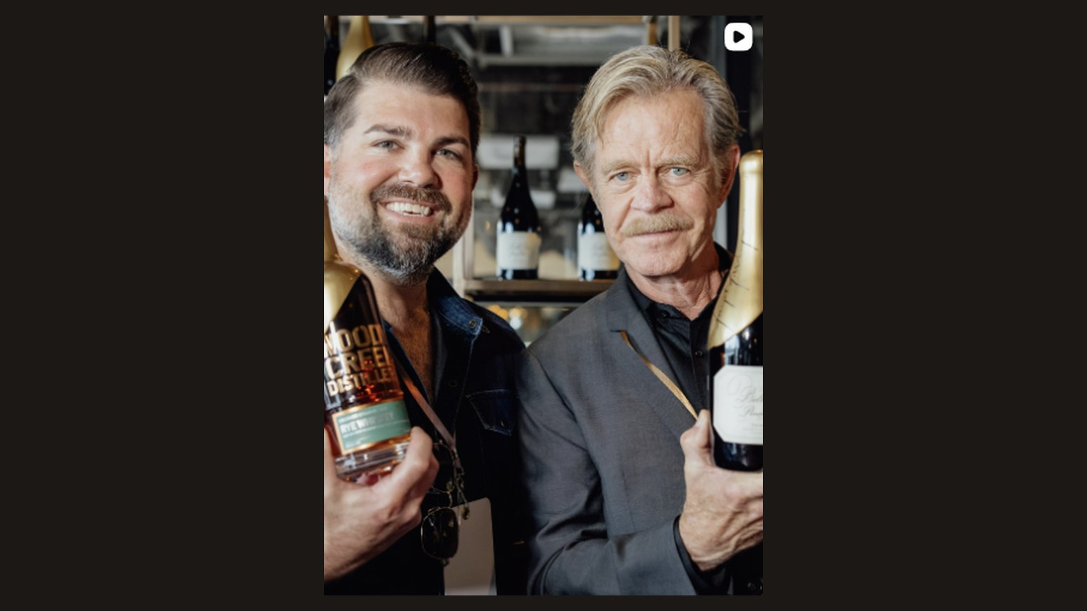Joe Wagner and William H. Macy. Joe holds a Belle Glos bottle. The rye bottle reads Wood Creek.