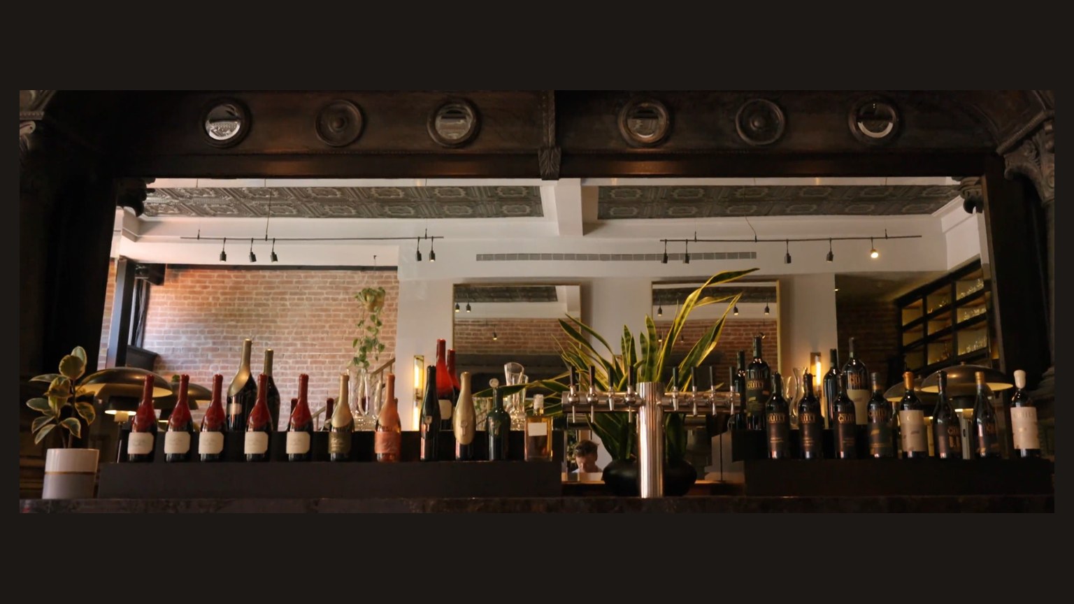A pass-through bar. Quilt Cabernet bottles stand on the right.