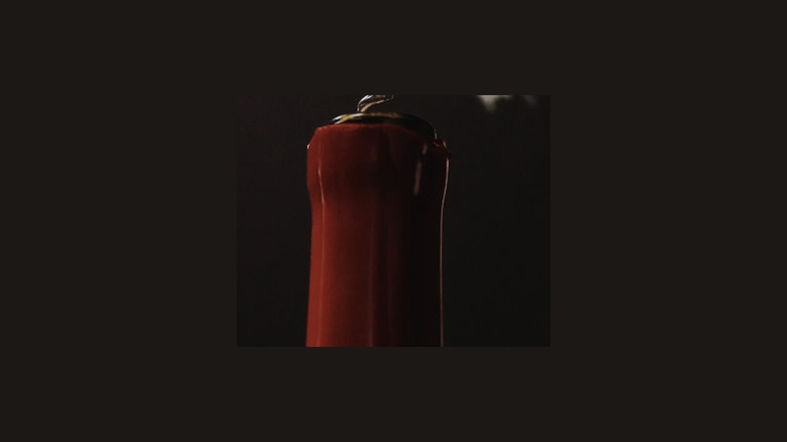 A close view of a red wax candle.