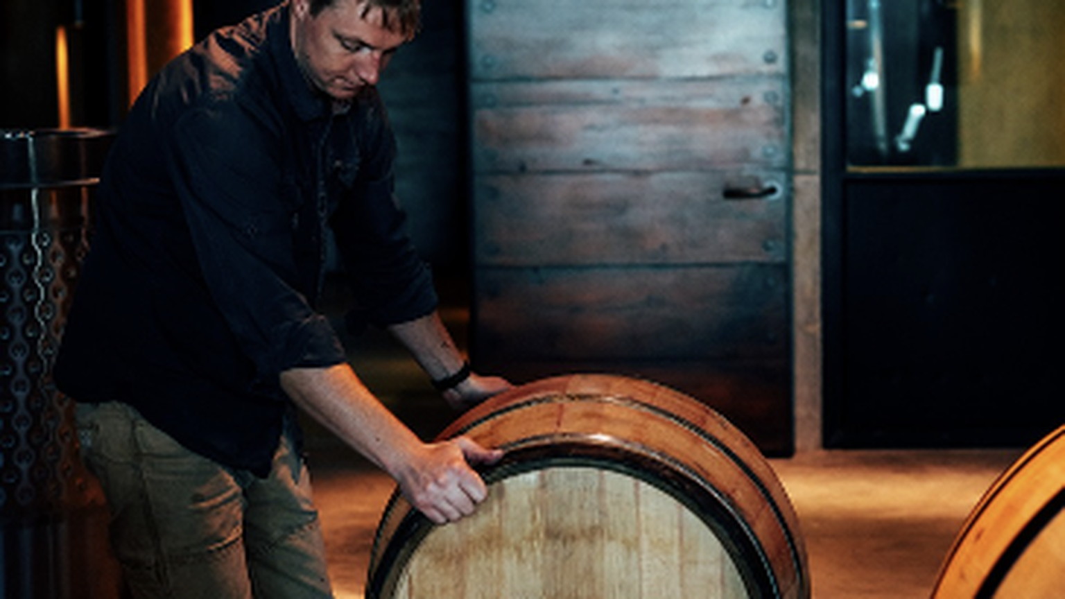 Rolling a barrel inside the Ovid cellar