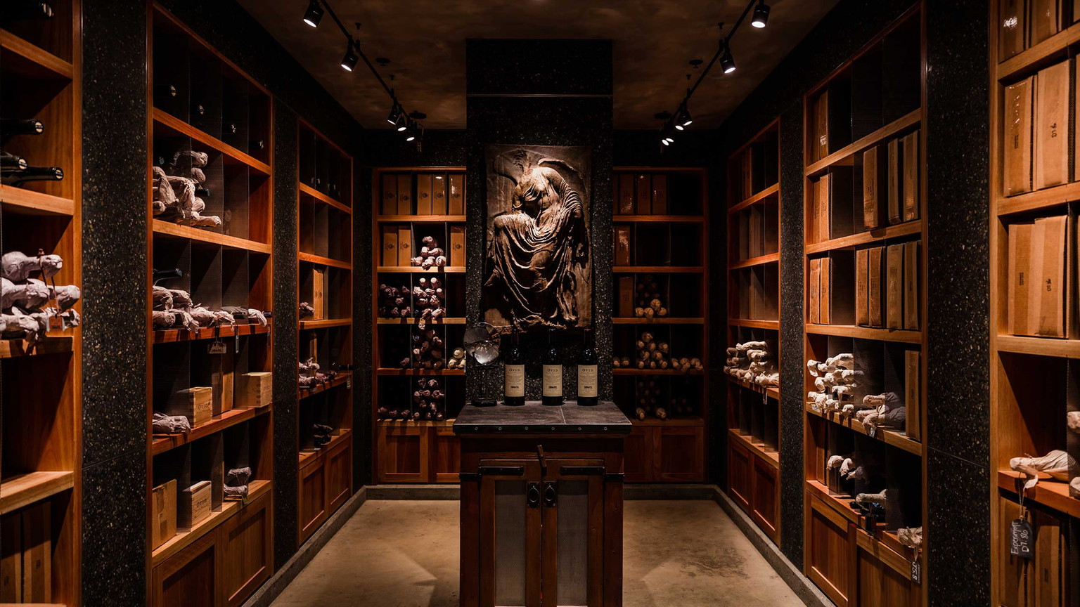 The Ovid library, with three bottles on a cabinet under a stone relief