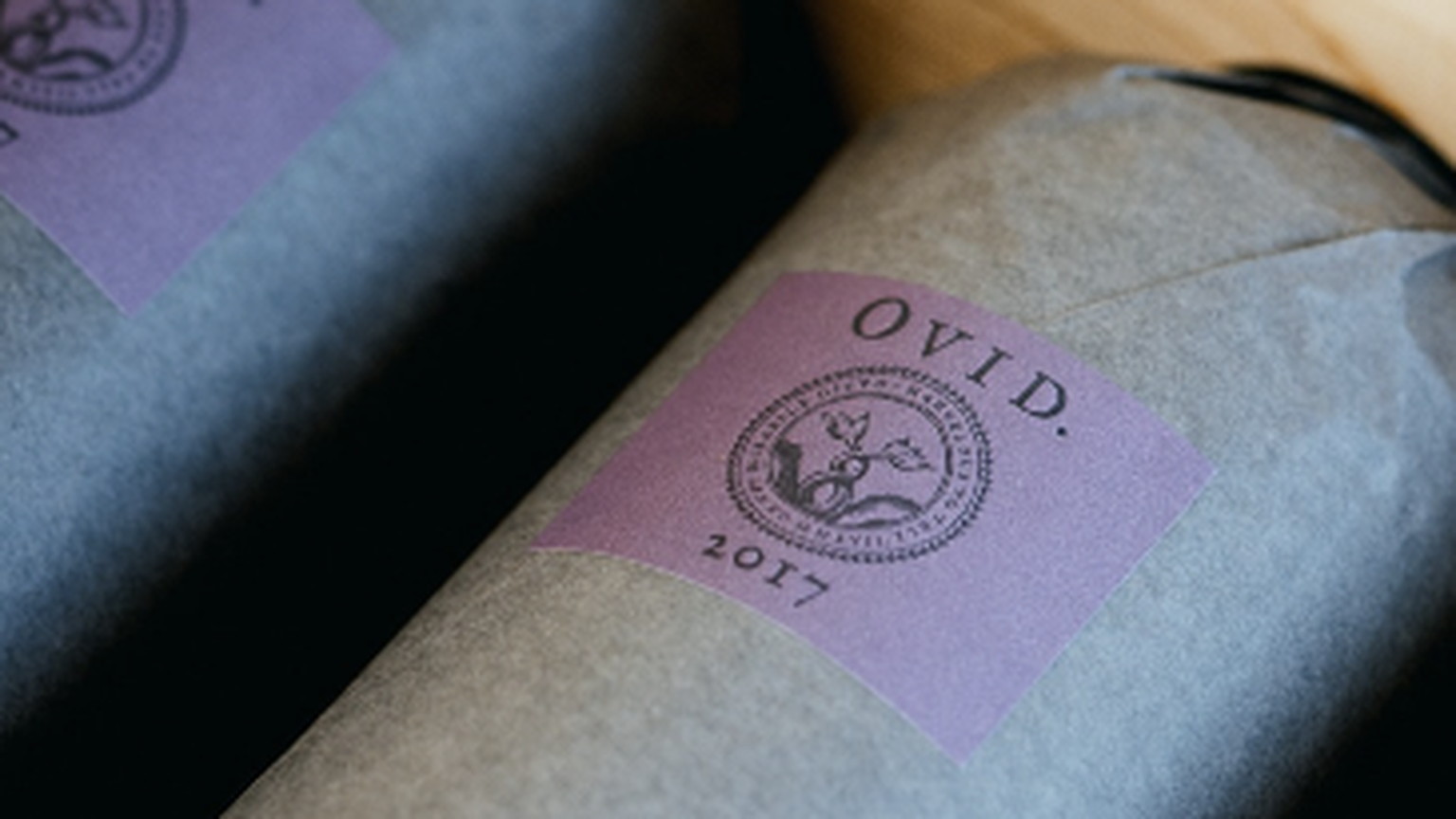 Tissue-wrapped Ovid bottles from the 2017, with a purple seal