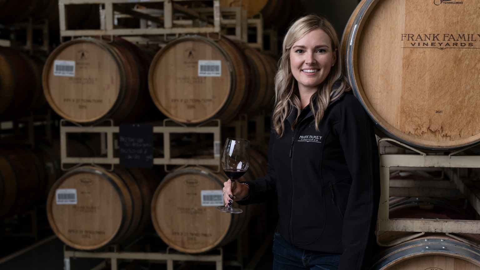 A woman with Frank Family barrels