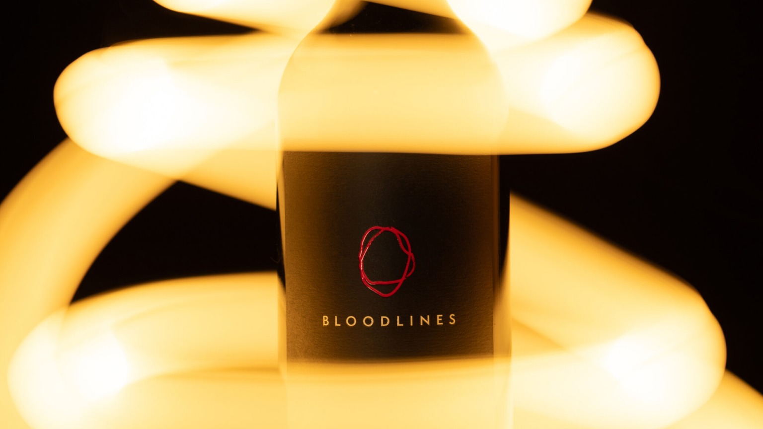 The Orin Swift Bloodlines bottle in yellow light