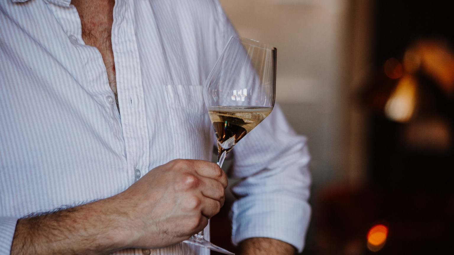 A guest with a glass at the Orin Swift tasting room