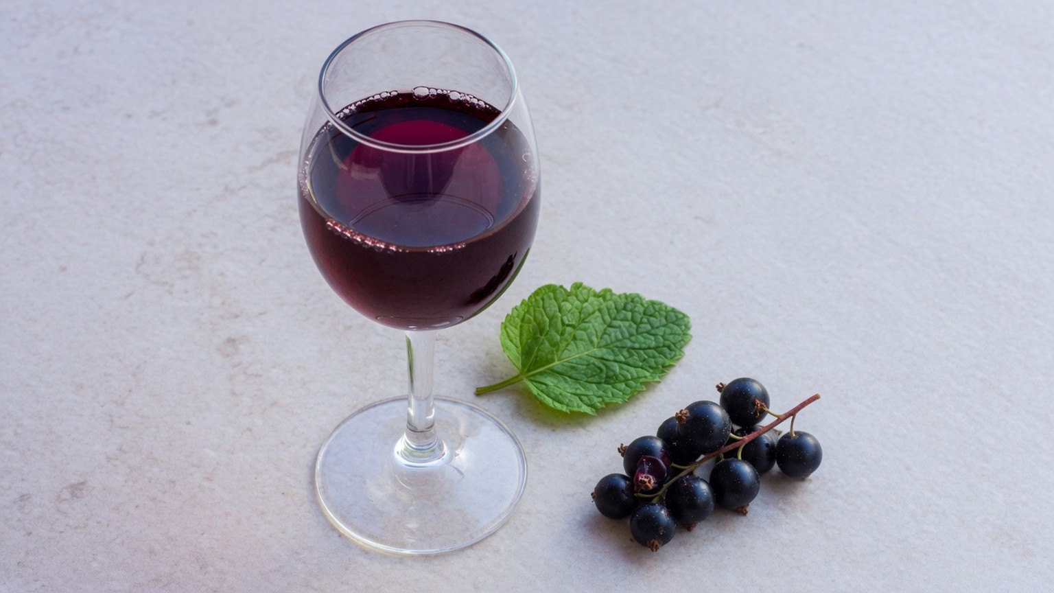 Generated still life, a glass of cabernet with mint and blackcurrants