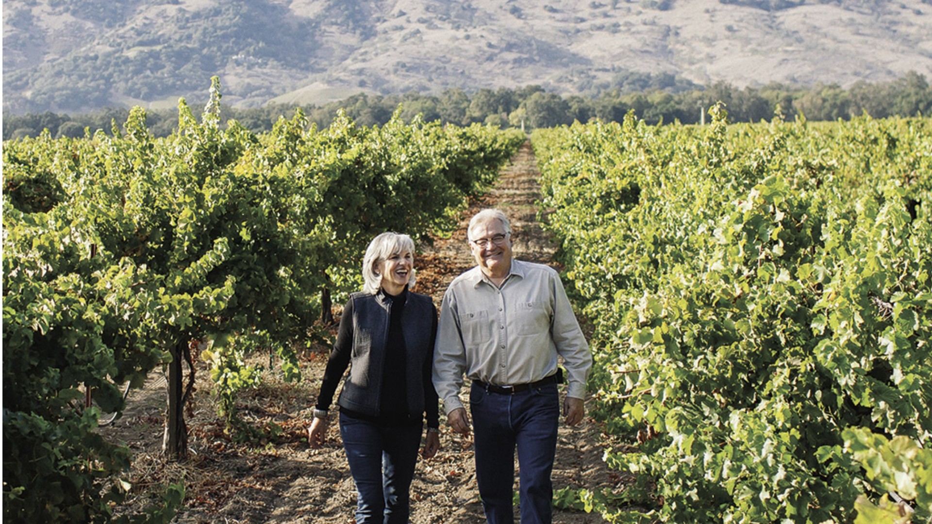 Randy and Megan Mason walking a Napa vineyard row