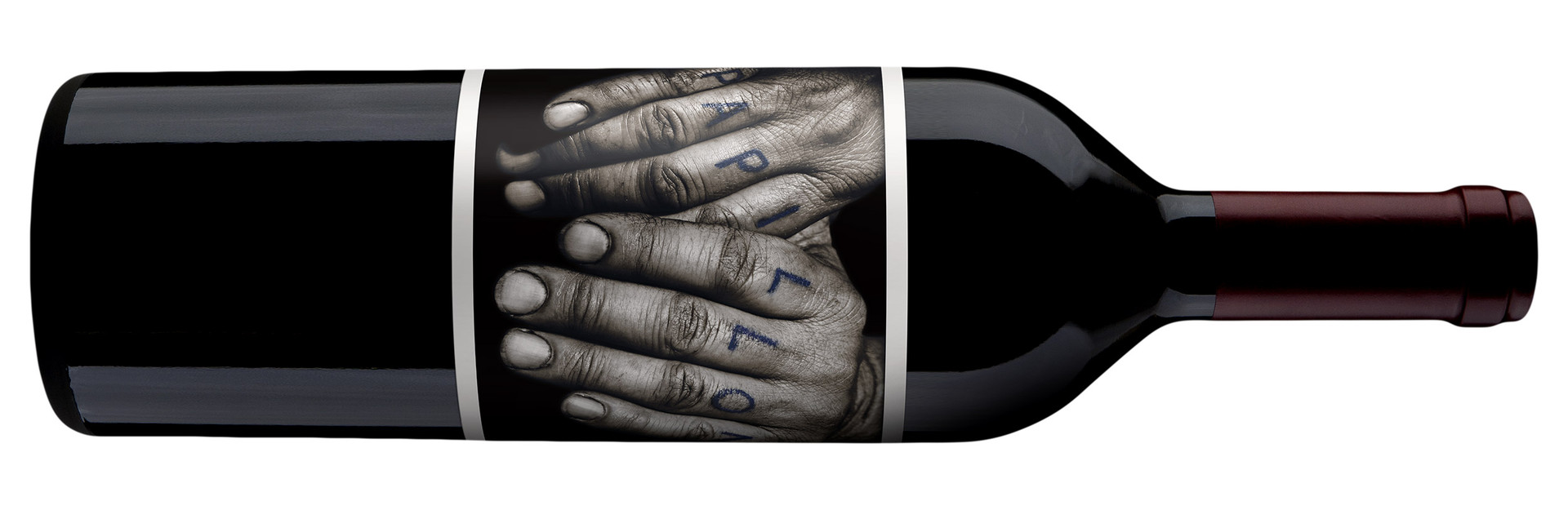 2022 Orin Swift Papillon bottle on its side, the hands label across the glass