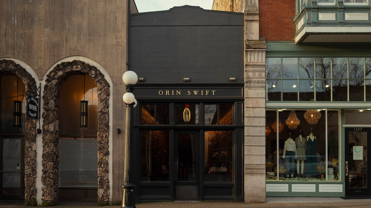 The Orin Swift tasting room storefront, gold letters above the black doors