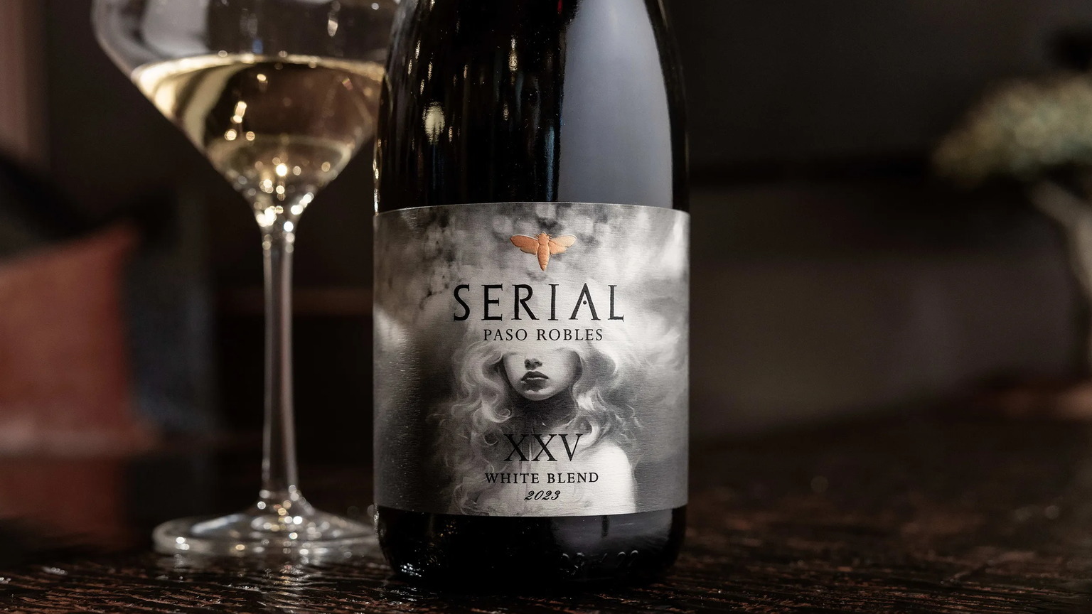 2023 Serial XXV White Blend beside a glass of the wine