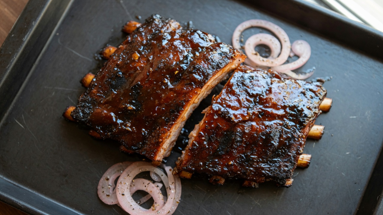 Glazed barbecue ribs on a tray, food only