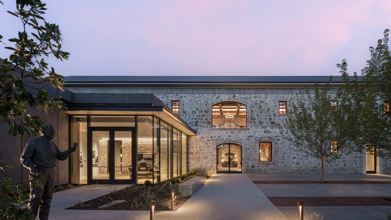 The Beaulieu Vineyard stone winery and glass entrance at dusk