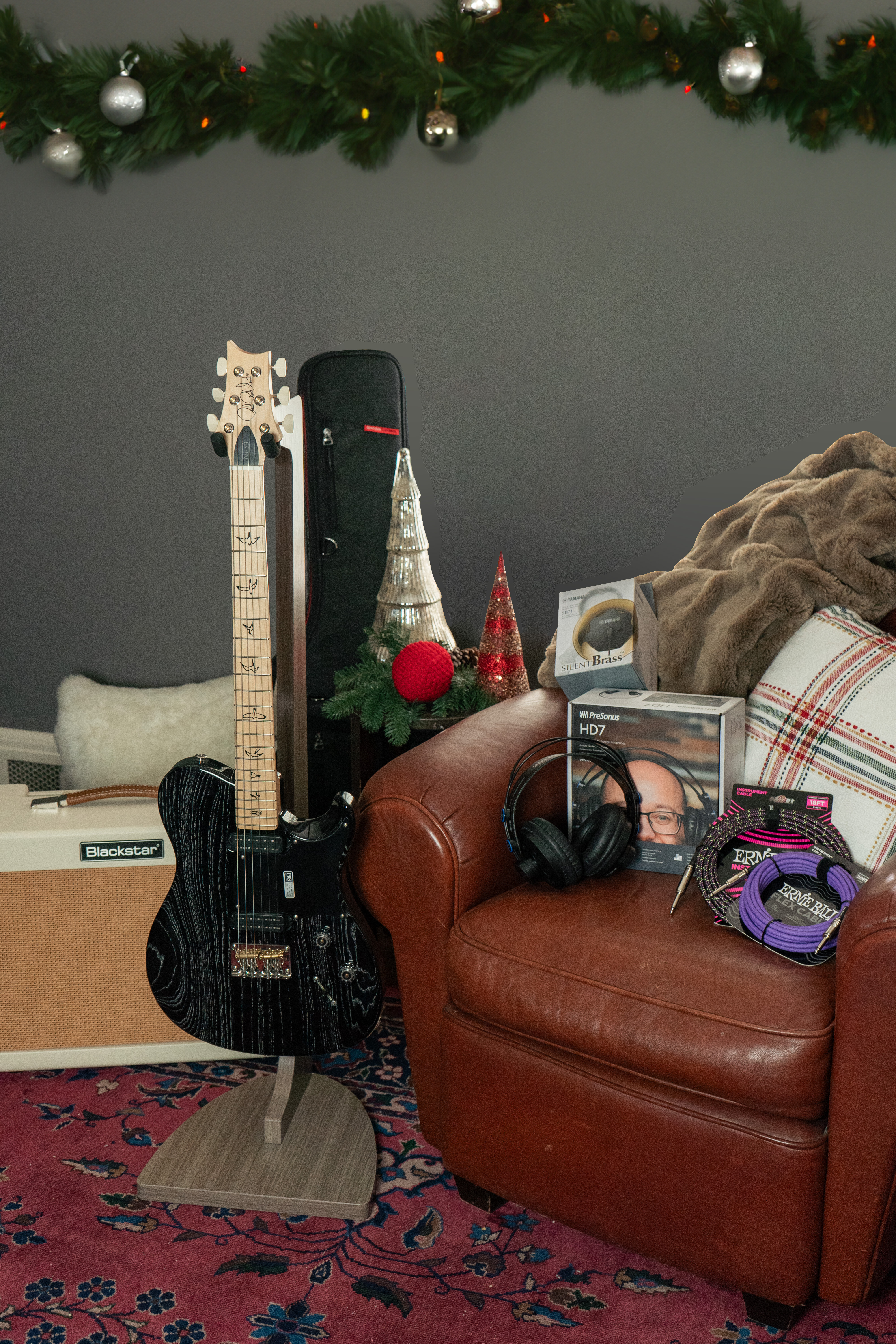 A Paul Reed Smith NF 53 electric guitar in a comfortable home with Christmas decor.