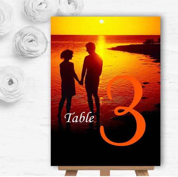 Couple On The Beach At Sunset Jetting Off Abroad Wedding Table Number Name Cards