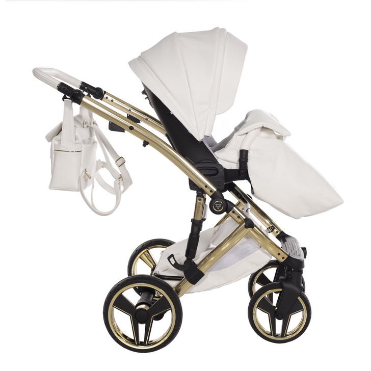 Side view of the Junama Candy Premium pram with the diamond carrycot. Shows frame detail, ventilation panel, and large wheels.