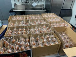"Sweet caramel-coated apples on sticks ready to be enjoyed at a fall festival." "Sweet caramel-coated apples on sticks ready to be enjoyed at a fall festival."