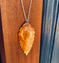 Amboyna, real wood veneer and sterling silver pendant designed and made by Jason and Esme, Grange Gallery, Dorset.