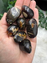 Sumatran Amber Tumbled Stone with deep golden brown tones. Fossilised tree resin for grounding, protection, stability, positive energy and creative self-expression.