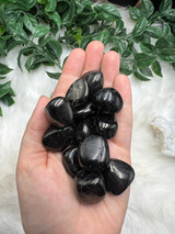 Jet Tumbled Stone, a glossy black fossilised wood for protection, grounding, grief support, emotional release, energy cleansing and stability.