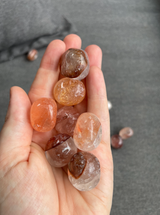 Hematoid Quartz Tumbled Stone with natural red, orange and golden hematite inclusions. A crystal for grounding, clarity, emotional balance and positive transformation.