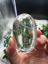 Shop this A Grade Clear Quartz Palmstone, featuring beautiful clarity and natural inclusions. A powerful crystal for focus, cleansing and energy amplification.