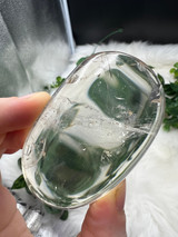 Shop this A Grade Clear Quartz Palmstone, featuring beautiful clarity and natural inclusions. A powerful crystal for focus, cleansing and energy amplification.