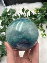 Discover an XL Rainbow Fluorite Sphere with stunning green, blue and purple tones and natural rainbow flash. A unique collector’s crystal for clarity and balance.