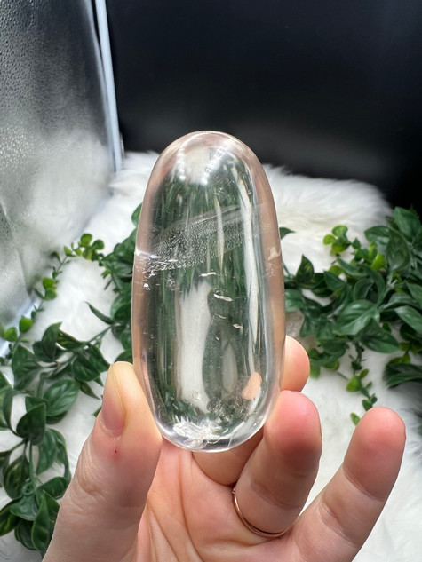 Shop this A Grade Clear Quartz Palmstone, featuring beautiful clarity and natural inclusions. A powerful crystal for focus, cleansing and energy amplification.