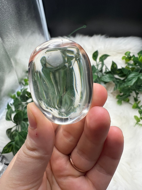 Shop this A Grade Clear Quartz Palmstone, featuring beautiful clarity and natural inclusions. A powerful crystal for focus, cleansing and energy amplification.