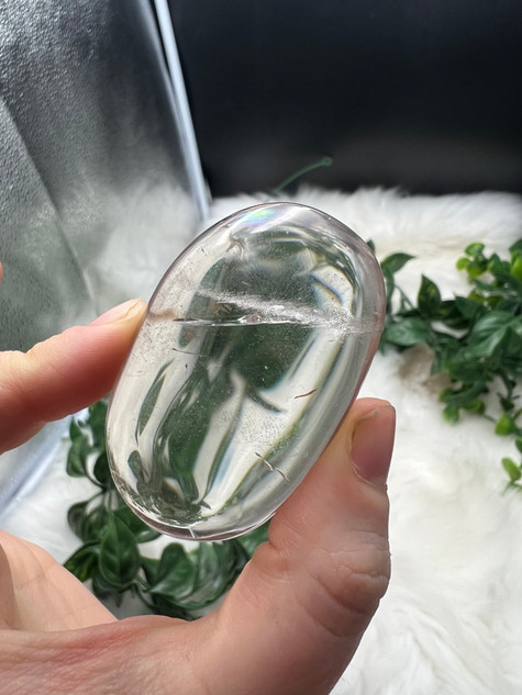 Shop this A Grade Clear Quartz Palmstone, featuring beautiful clarity and natural inclusions. A powerful crystal for focus, cleansing and energy amplification.
