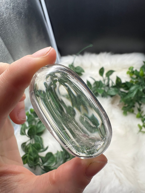 Shop this A Grade Clear Quartz Palmstone, featuring beautiful clarity and natural inclusions. A powerful crystal for focus, cleansing and energy amplification.