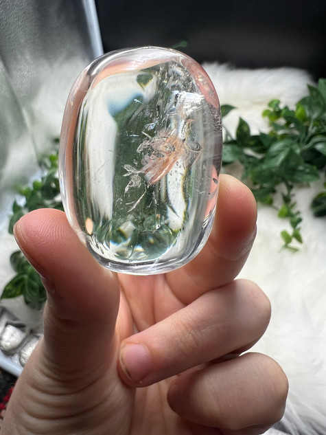 Shop this A Grade Clear Quartz Palmstone, featuring beautiful clarity and natural inclusions. A powerful crystal for focus, cleansing and energy amplification.