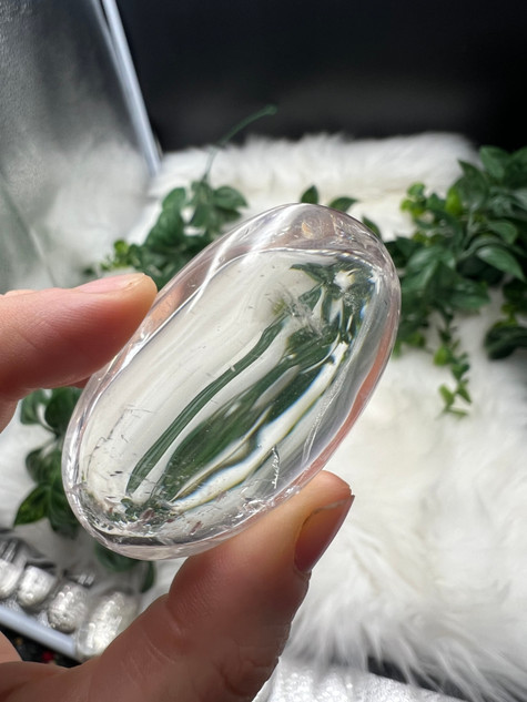 Shop this A Grade Clear Quartz Palmstone, featuring beautiful clarity and natural inclusions. A powerful crystal for focus, cleansing and energy amplification.