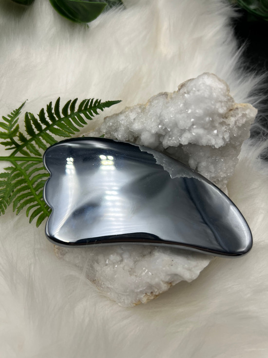 Terahertz gua sha tool with a sleek polished silver finish. A beautiful crystal beauty tool for facial massage, energy flow, clarity and mindful self-care rituals.