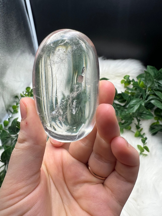 Shop this A Grade Clear Quartz Palmstone, featuring beautiful clarity and natural inclusions. A powerful crystal for focus, cleansing and energy amplification.