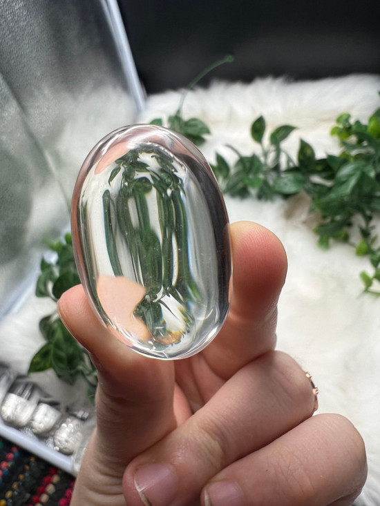 Shop this A Grade Clear Quartz Palmstone, featuring beautiful clarity and natural inclusions. A powerful crystal for focus, cleansing and energy amplification.