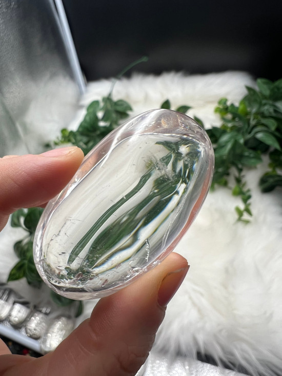 Shop this A Grade Clear Quartz Palmstone, featuring beautiful clarity and natural inclusions. A powerful crystal for focus, cleansing and energy amplification.