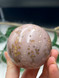 Beautiful Bubblegum Jasper sphere with soft pink tones and sparkling golden inclusions.